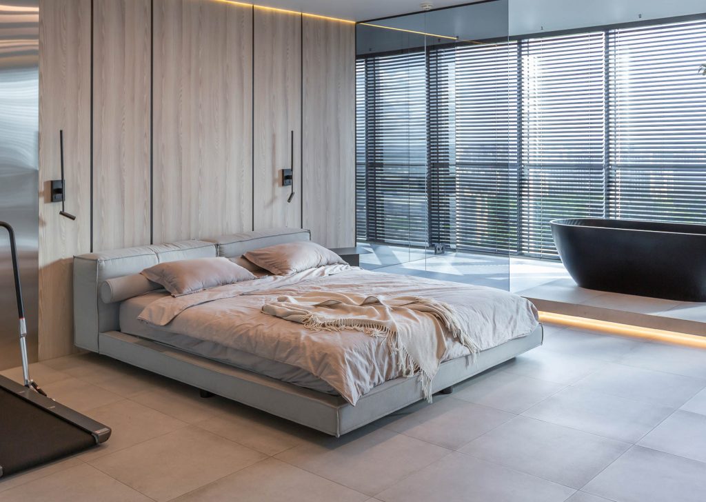 modern minimalistic soft design room interior in Japanese style in beige and black colors. stylishly detached bathroom by a huge panoramic window with blinds